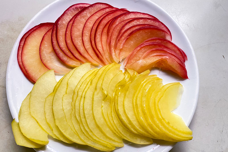 薄切りのリンゴを皿に並べる